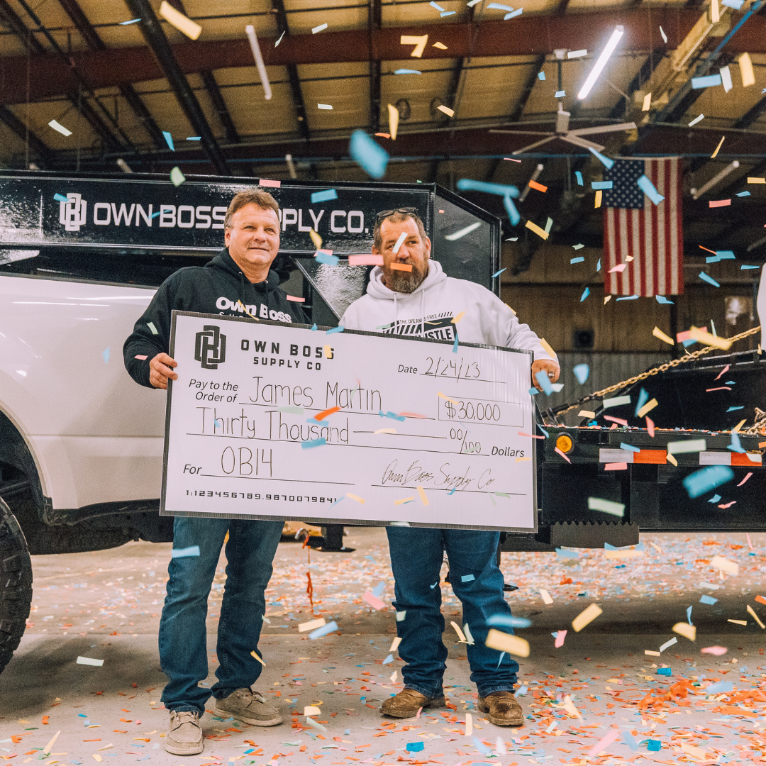 Two men celebrate with large $30,000 check amid falling confetti