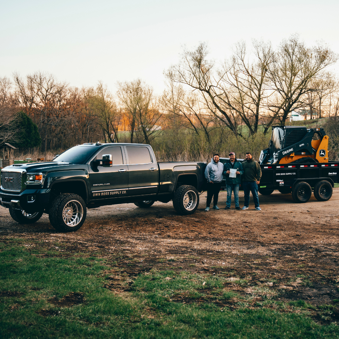 GMC truck and John Deere equipment with team from Own Boss Supply Co