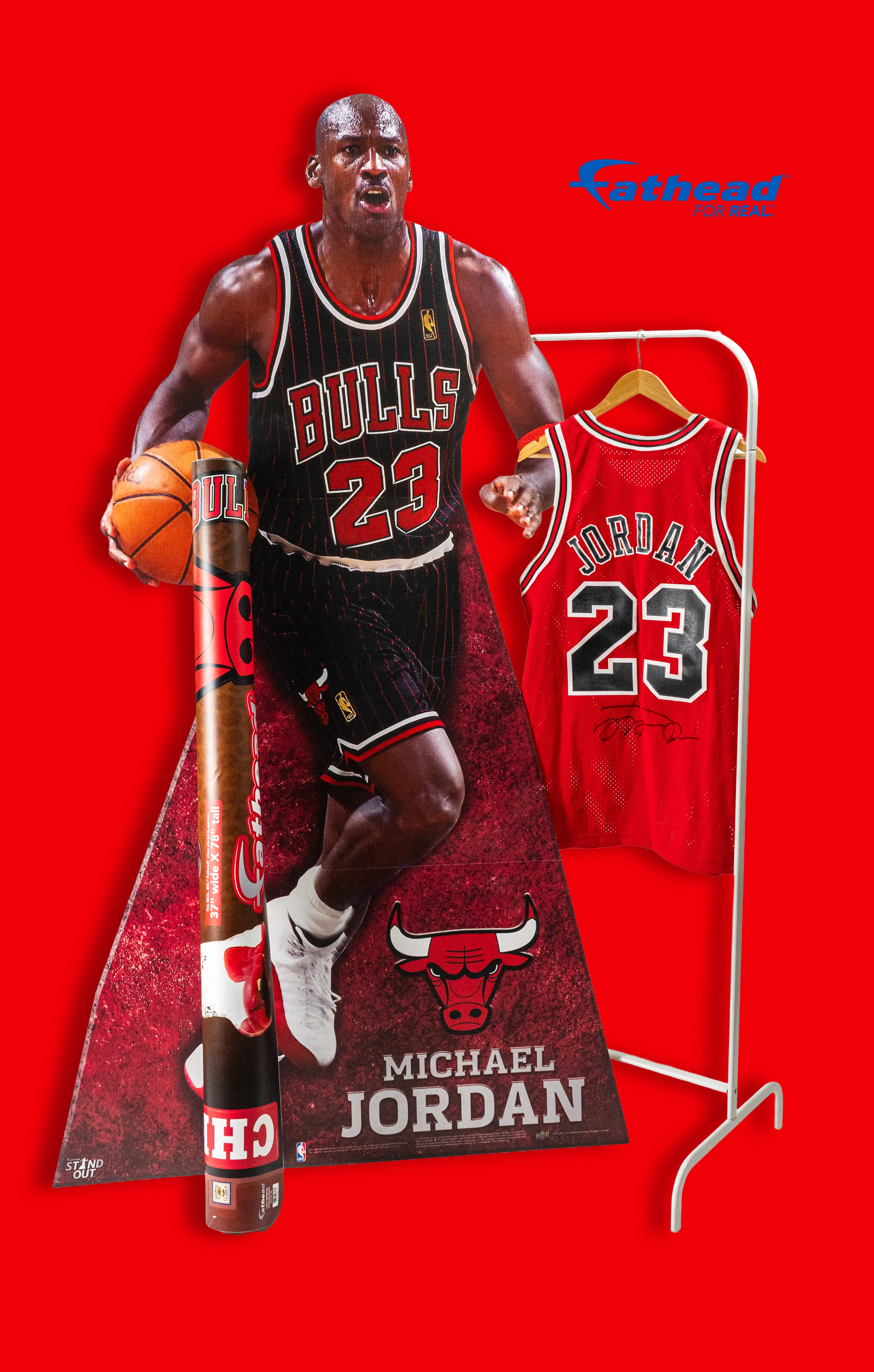 A life size cardboard cutout of Michael Jordan next to a jersey and rolled up poster
