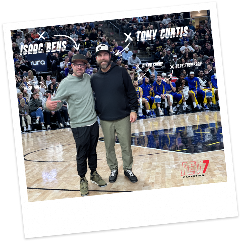 A photo of Red7's Isaac Beus and Tony Curtis at a basketball game