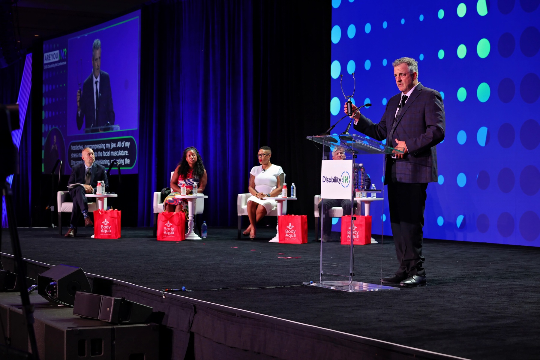 Joe Meisch, CEO of Temple Massager and winner of the 2025 Pitch Perfect Challenge gives is pitch to a panel of judges at the DisabilityIN Conference