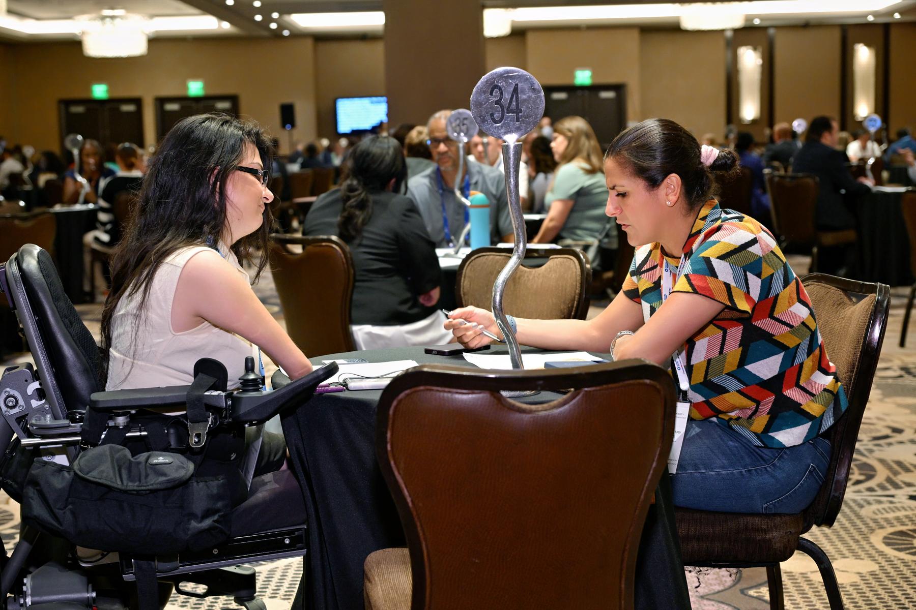 A NextGen leader in at a roundtable engaged in a conversation with her mentor.