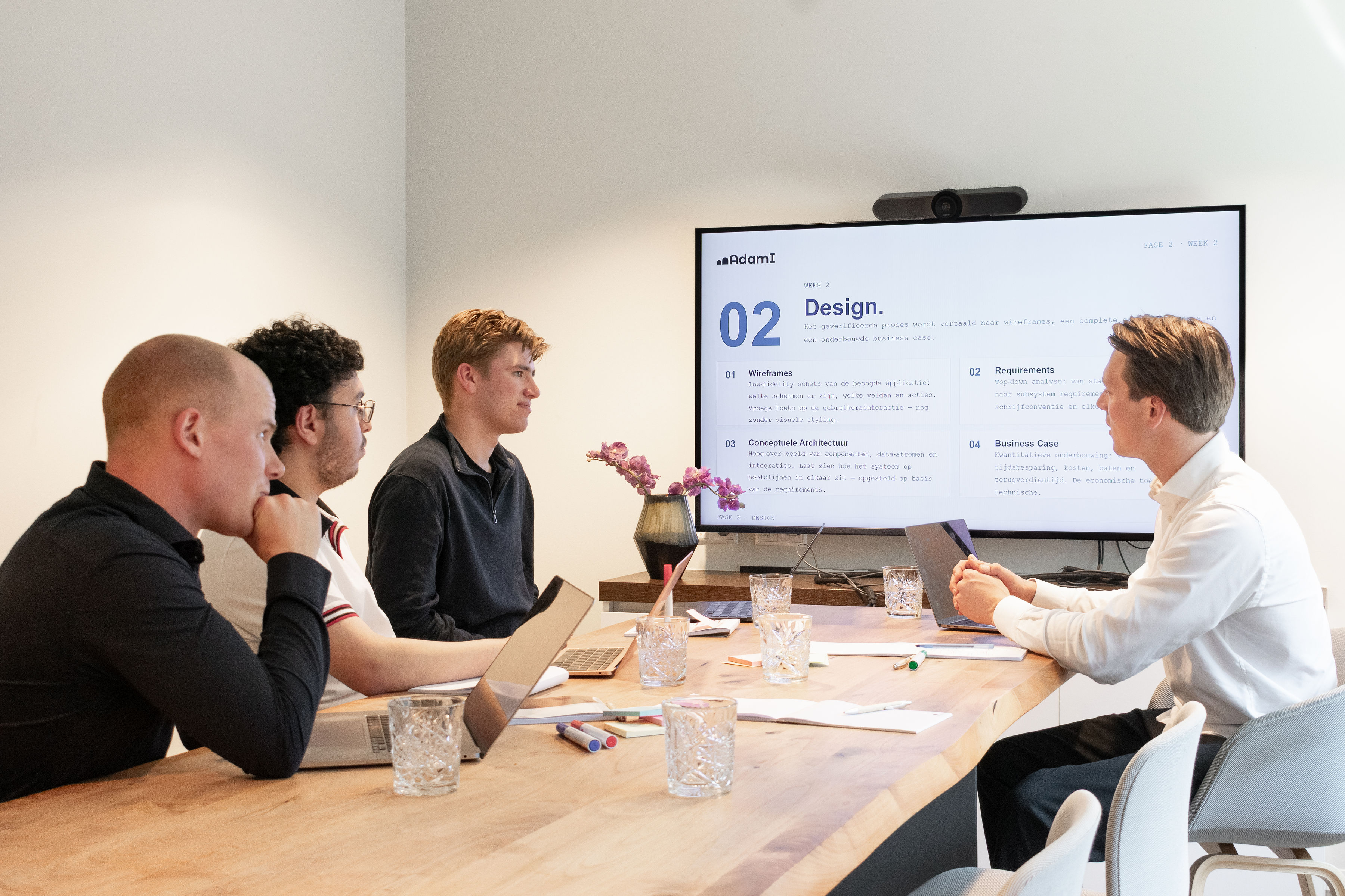 AdamI team in a design session reviewing wireframes, requirements and the business case