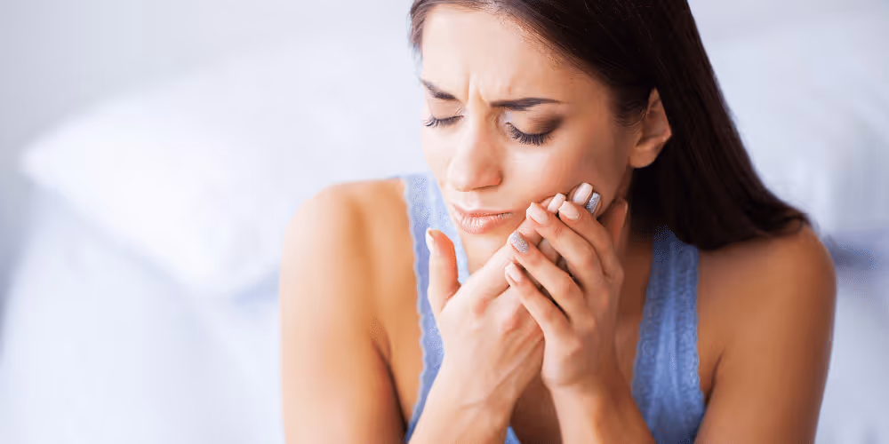 woman having pain from dental implant
