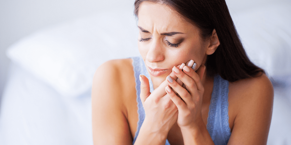 woman having pain from dental implant