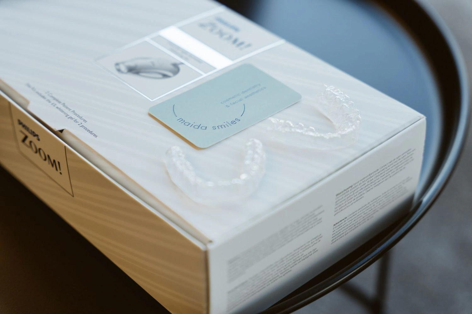 Philips Zoom teeth whitening kit box with clear whitening trays and a Maida Smiles card