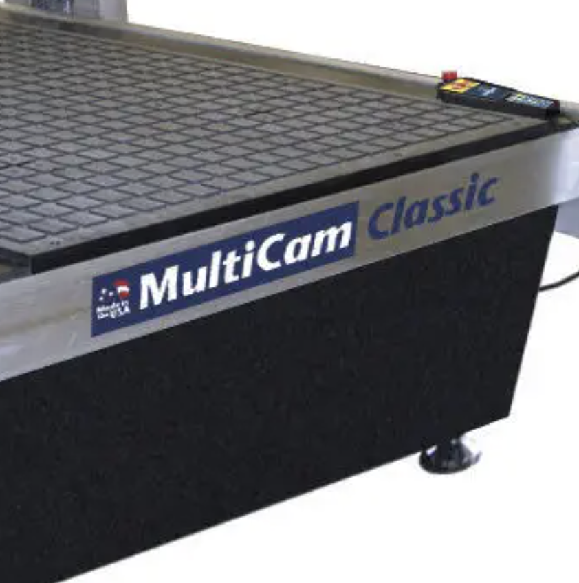 MultiCam Classic cutting table with a textured surface and control panel.