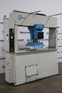 Large industrial white and blue hydraulic press machine with control panel on the left side.