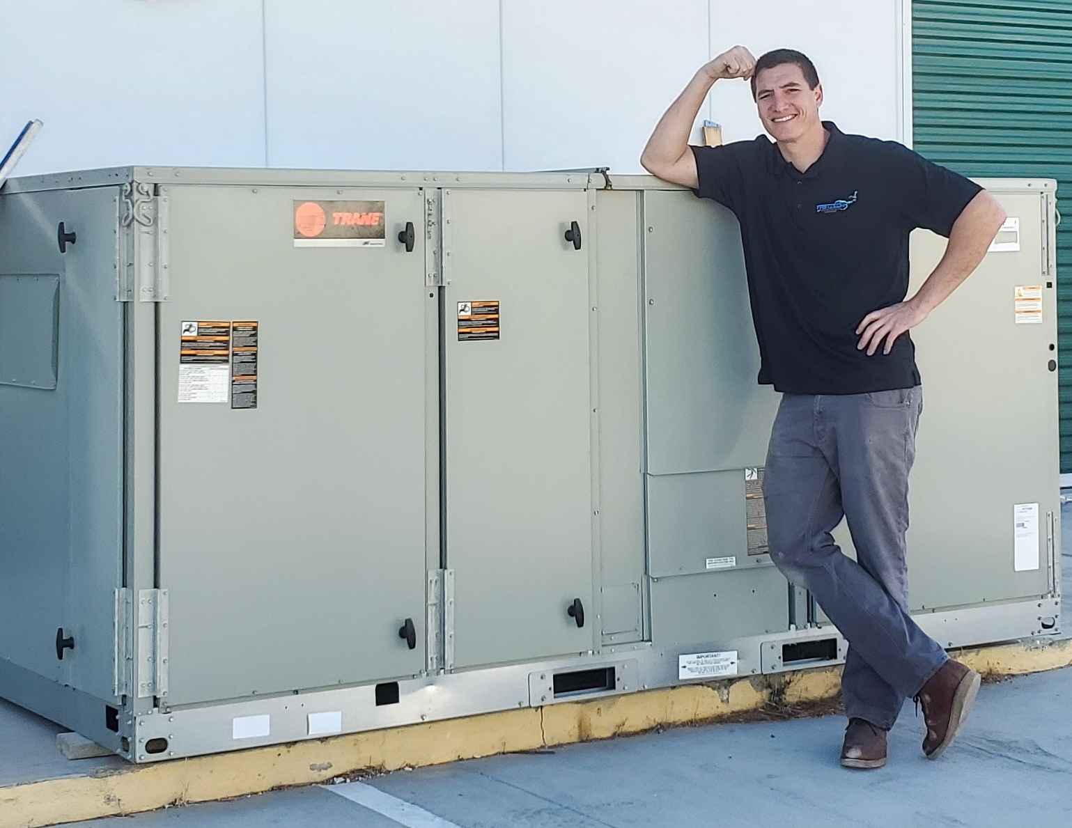 CEO Sean Cornelis leaning on a commercial HVAC unit