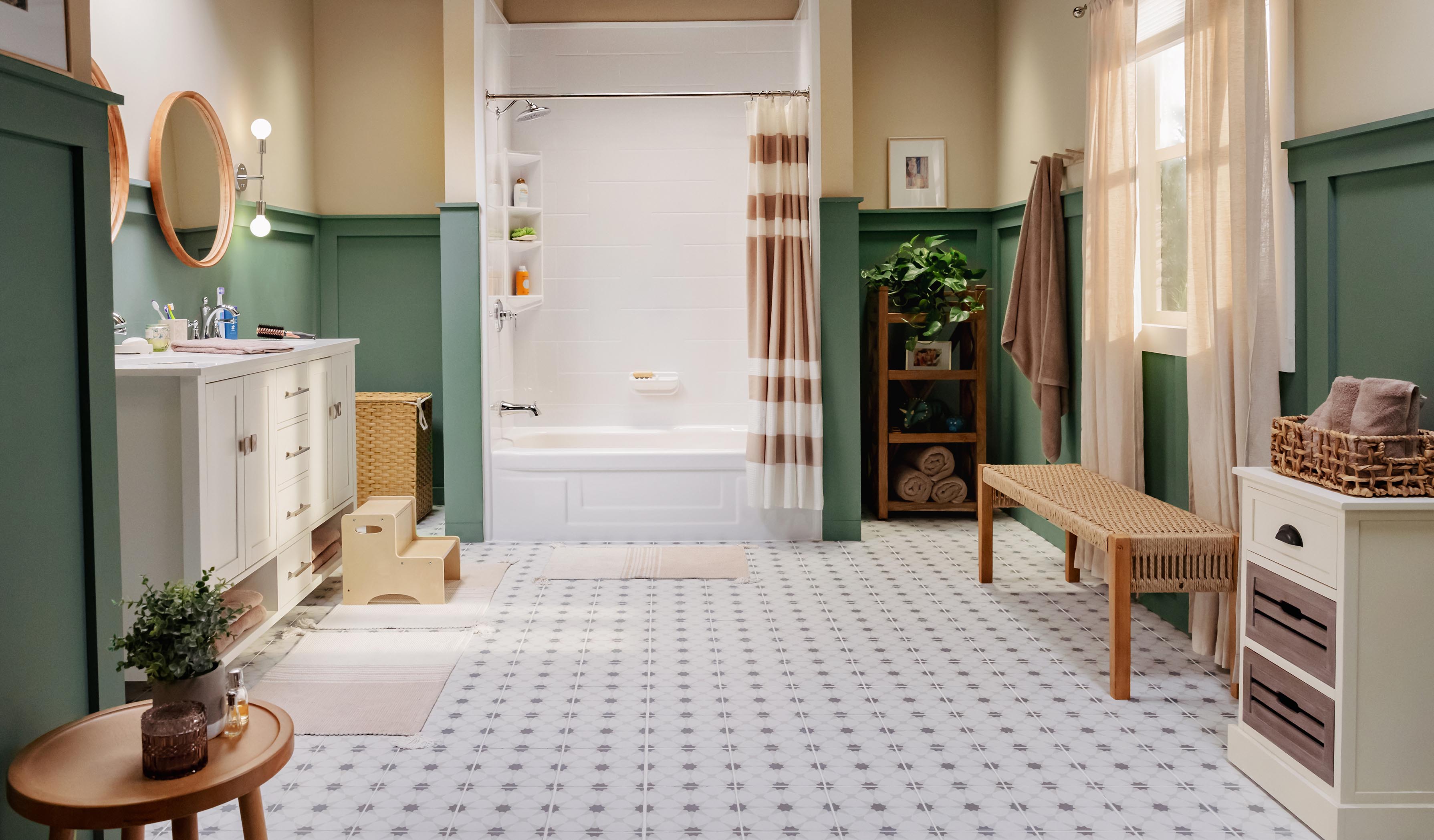 Spacious bathroom with white vanity, twin round mirrors, and a bathtub-shower combo featuring a striped curtain. Includes green wainscoting, natural wood accents, decorative plants, and patterned tile flooring.