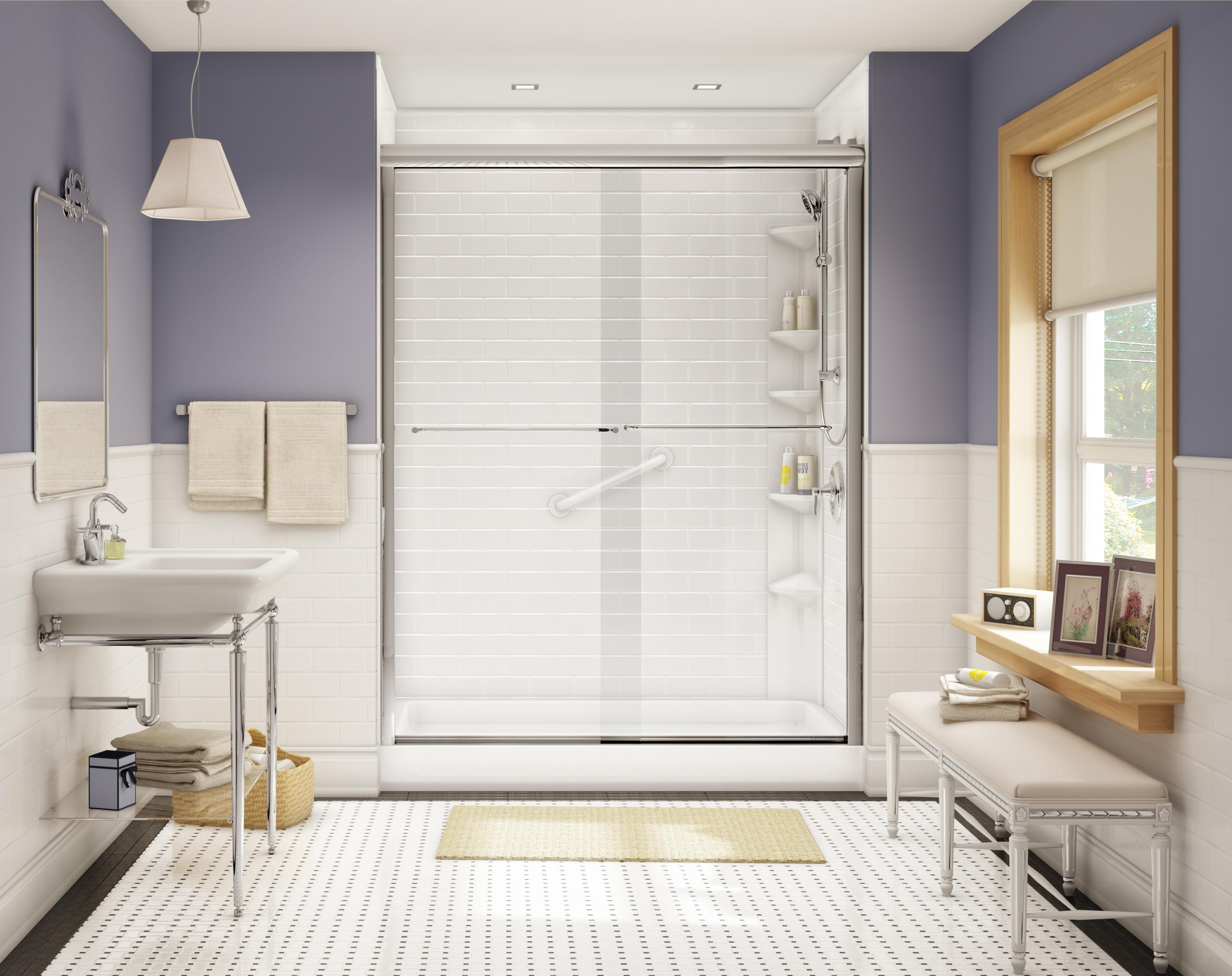 Modern bathroom with a walk-in shower featuring sliding glass doors, white subway tile walls, built-in shelving, and a safety grab bar. The room includes a wall-mounted sink, chrome fixtures, a bench by the window, lavender accent walls, and a patterned tile floor.