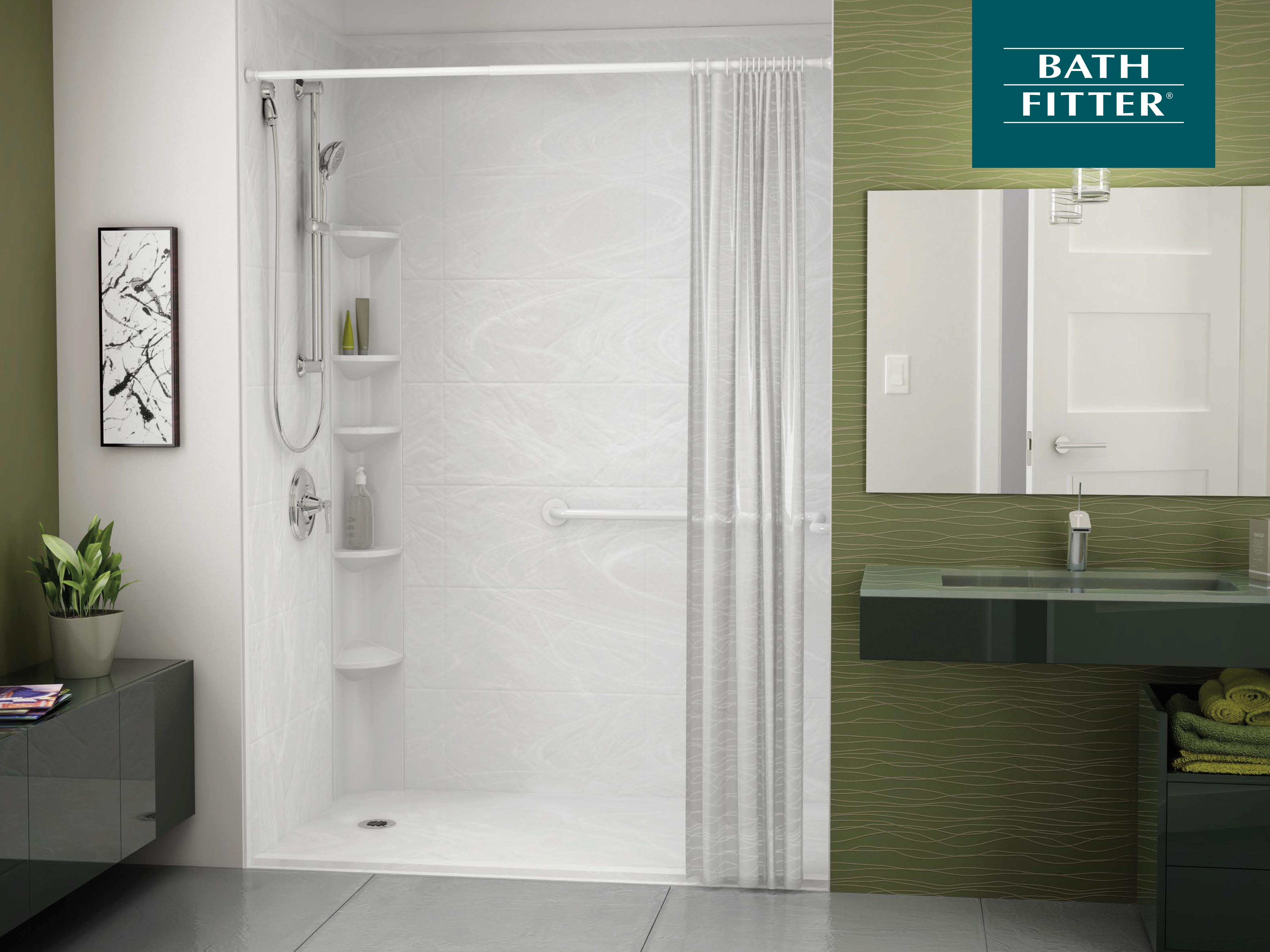 Modern walk-in shower with white marbled wall panels, built-in corner shelving, a handheld showerhead, and a clear curtain. The adjacent olive green accent wall features a sleek dark green floating vanity with a wide mirror above and folded green towels stored below. Decor includes a potted plant and abstract wall art.