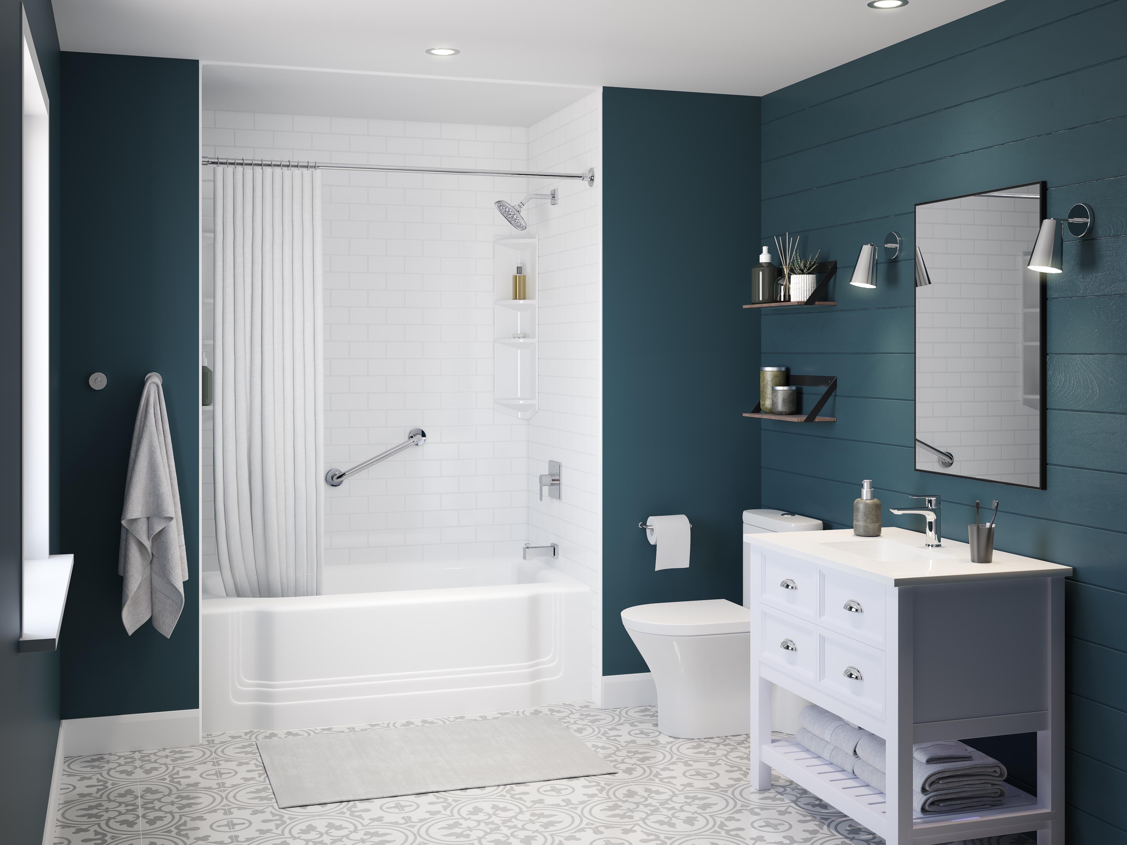 Contemporary bathroom with white subway tile shower surround, safety grab bar, and sleek fixtures. The deep blue accent wall contrasts with the crisp white vanity, modern lighting, and patterned floor tiles. Floating shelves display decor and toiletries, adding both style and function.