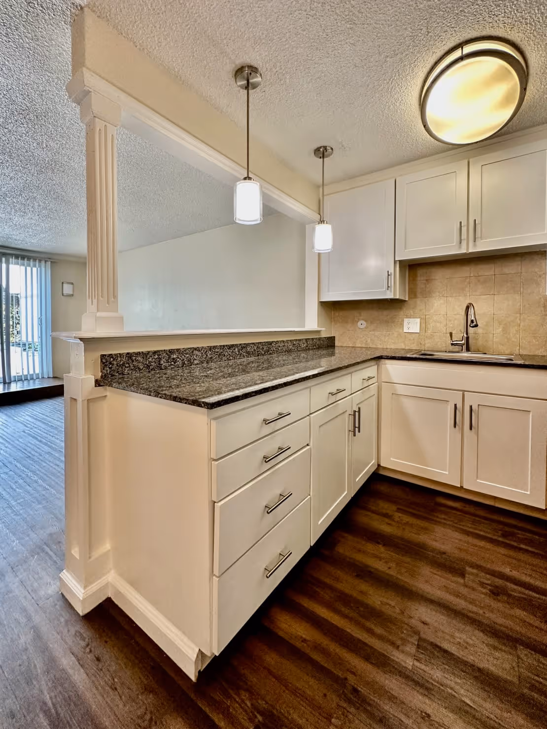 kitchen and living area with view of patio