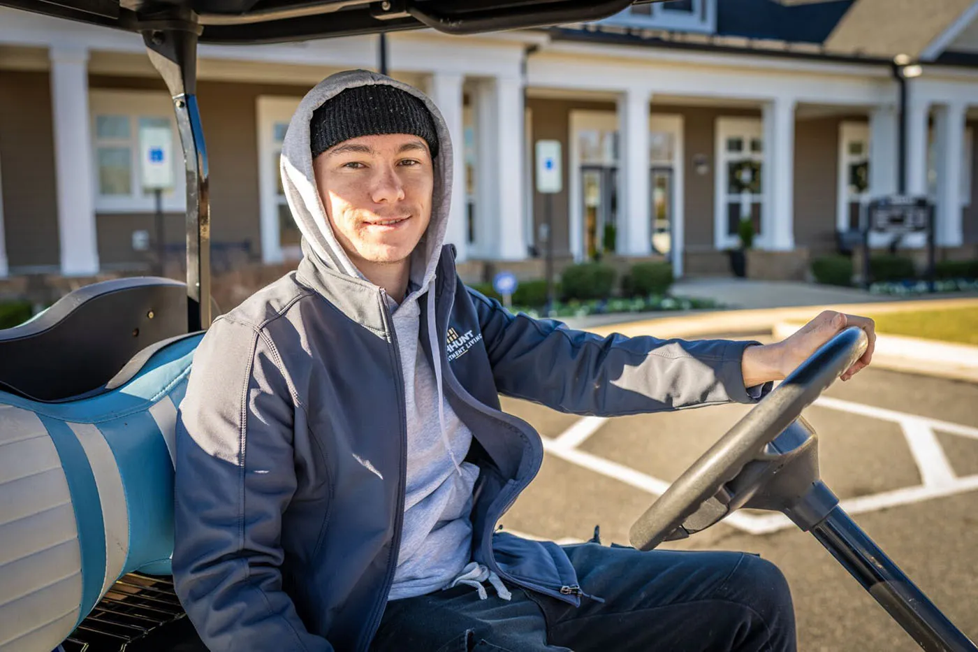 HHHunt Apartment Living employee in a golf cart