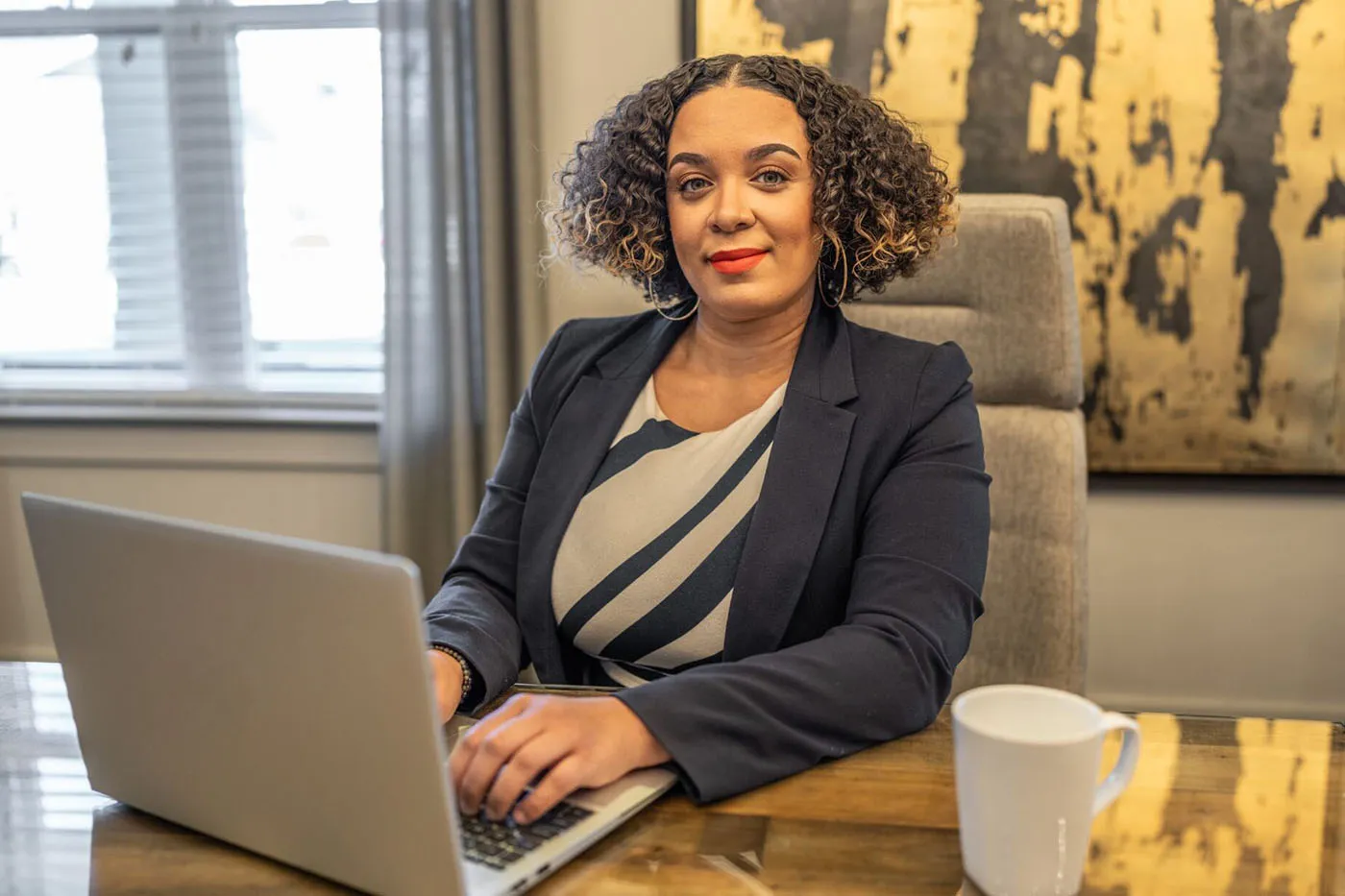 HHHunt employee at her desk with her laptop open