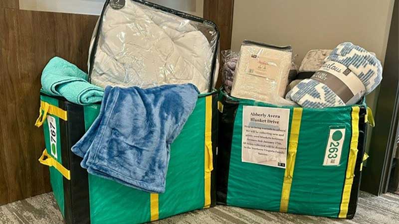 Two donation bags filled with various items.