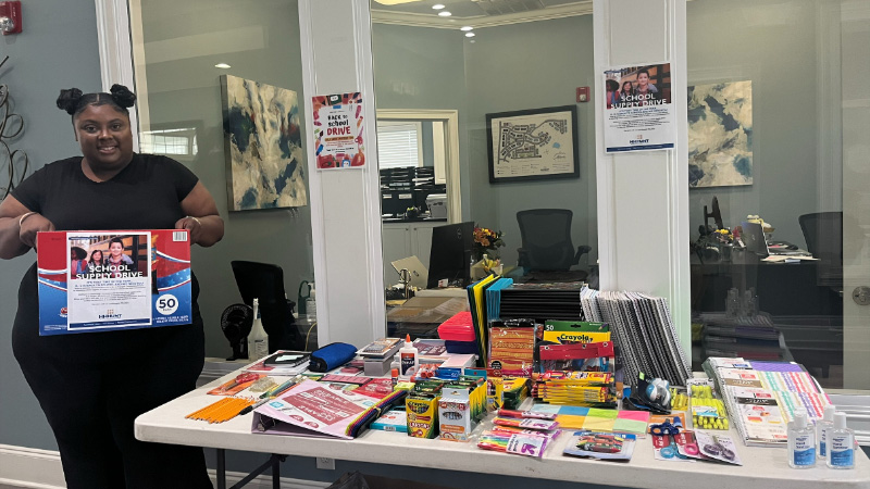 Woman standing around table of supplies