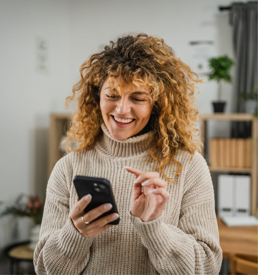 happy woman looking at her phone