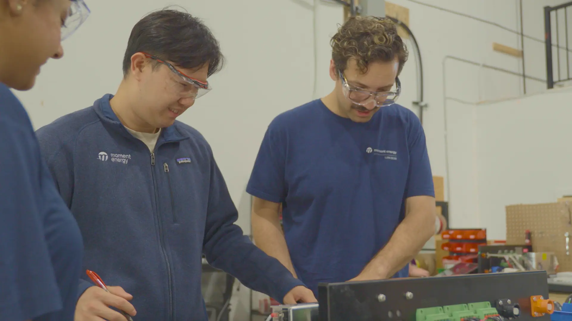 Two Moment Energy employees working together.