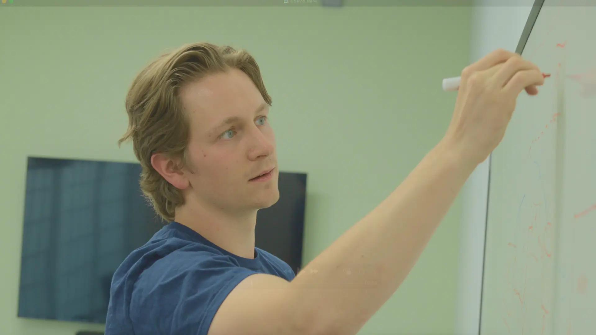 Moment Energy employee drawing something on a whiteboard.