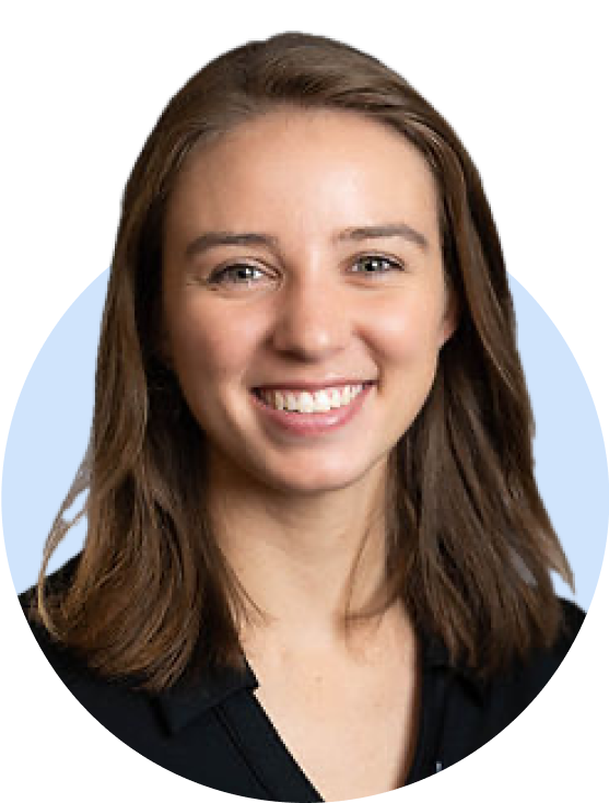Professional headshot of a smiling woman in black jacket, light background