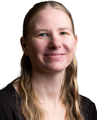 Smiling person with long blonde hair and glasses wearing black shirt