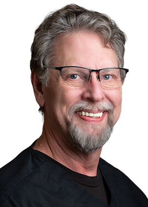 Smiling middle-aged man with glasses and gray beard in black shirt