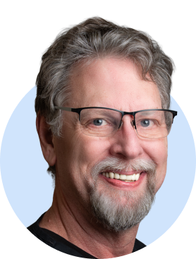 Middle-aged man with glasses smiling in professional headshot