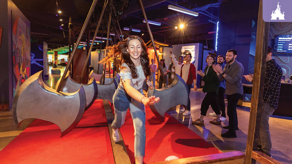 Claude responded: Woman dodging swinging axe obstacles at Level99 Disney Springs, an immersive adult gaming venue with colorful art installationsWoman dodging swinging axe obstacles at Level99 Disney Springs, an immersive adult gaming venue with colorf
