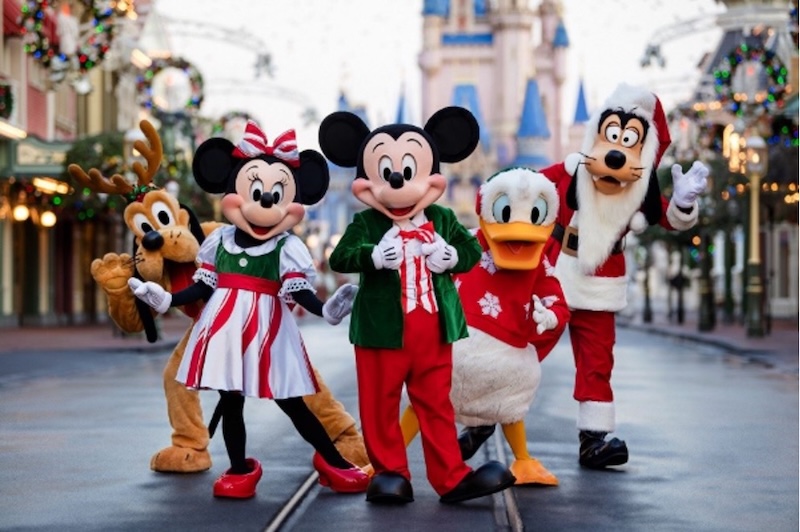 Mickey Mouse, Minnie Mouse, Pluto, Donald Duck, and Goofy in holiday outfits on Main Street U.S.A. at Magic Kingdom during Mickey's Very Merry Christmas Party
