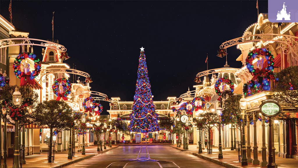 Towering Christmas tree glows with lights on Main Street, U.S.A. at Magic Kingdom, framed by wreaths and holiday decor.