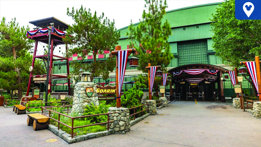 Soarin' Across America entrance at Disneyland Resort with patriotic bunting, wooden lookout tower, and signage leading to the attraction.