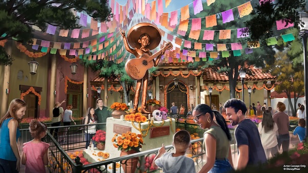 Bronze mariachi skeleton statue playing guitar in a plaza decorated with papel picado banners and marigold garlands as visitors look on