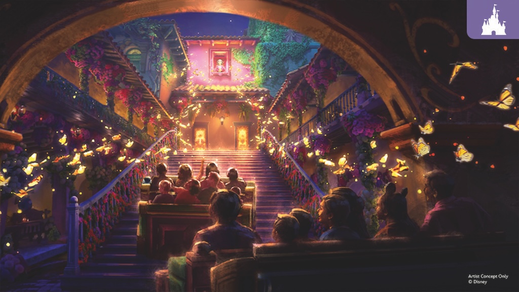Ride passengers in two rows ascend a flower-adorned staircase under arched ceiling, glowing butterflies flutter around vine-covered balconies.