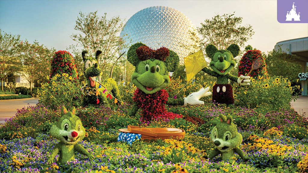 Topiary sculptures of cartoon mice (female with bow, male with racket), a dog, and two chipmunks amid flower beds with a geodesic dome behind