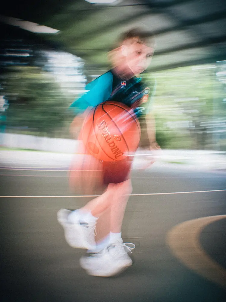 A participant dribbles past the camera, his movement blurred.