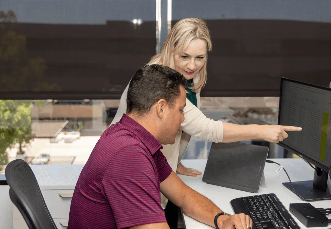Real Estate Professionals in the office having a discussion at a desk 