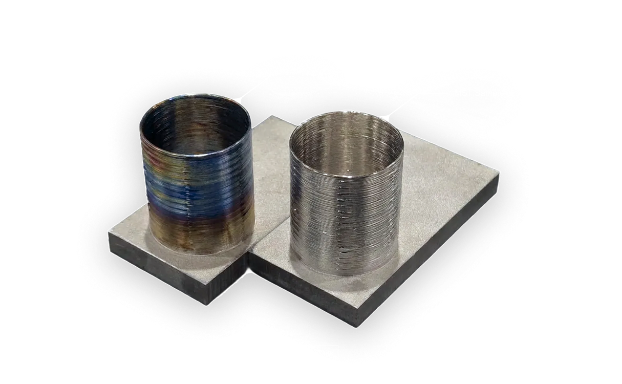 Two Ti64 cylindrical samples mounted on rectangular blocks, labeled as Non-MST Sample on the left with severe oxidation, labeled as MST Sample on the right with no oxidation