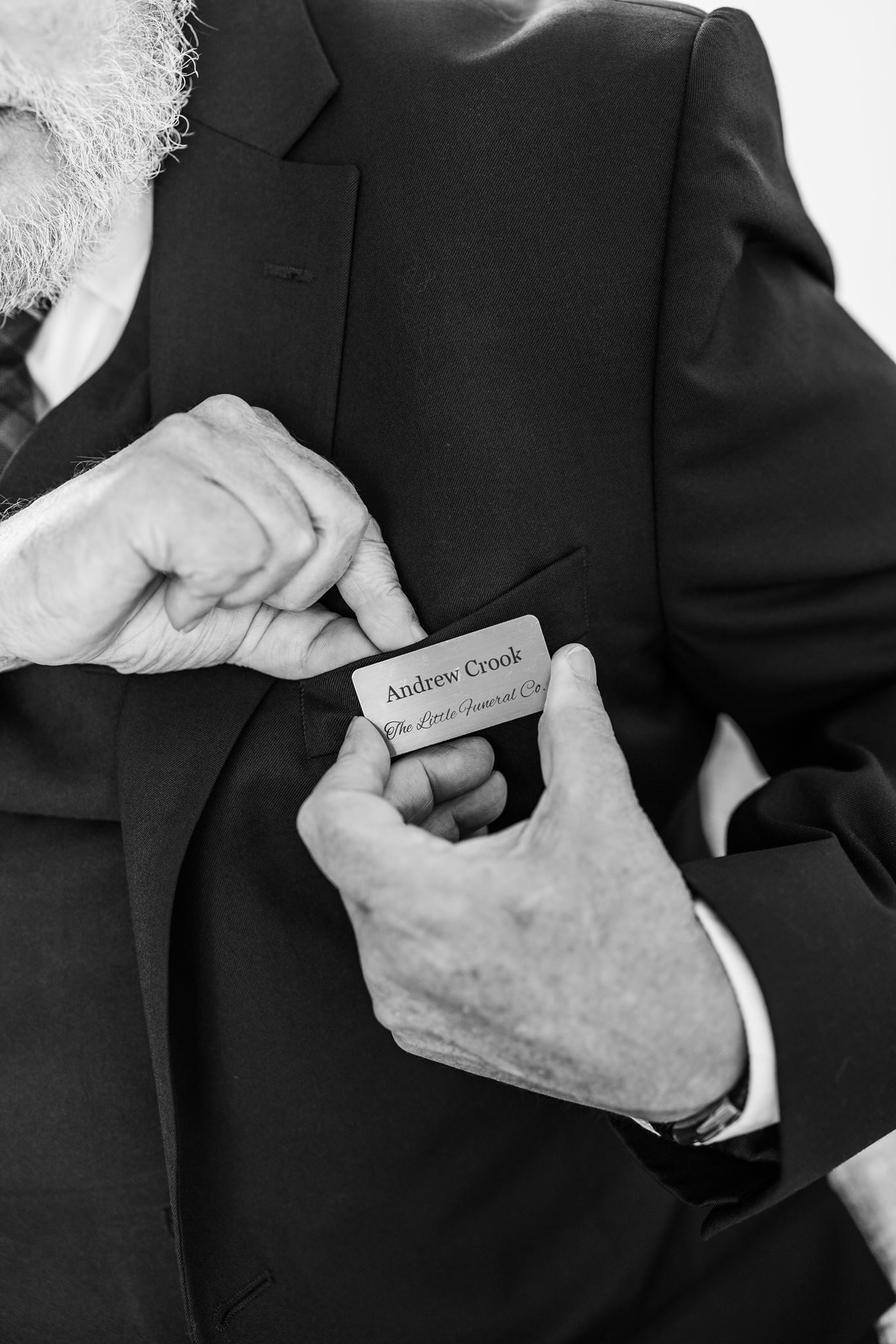 Close-up of funeral director Andrew Crook wearing a Little Funeral Company name tag in Northern Beaches NSW