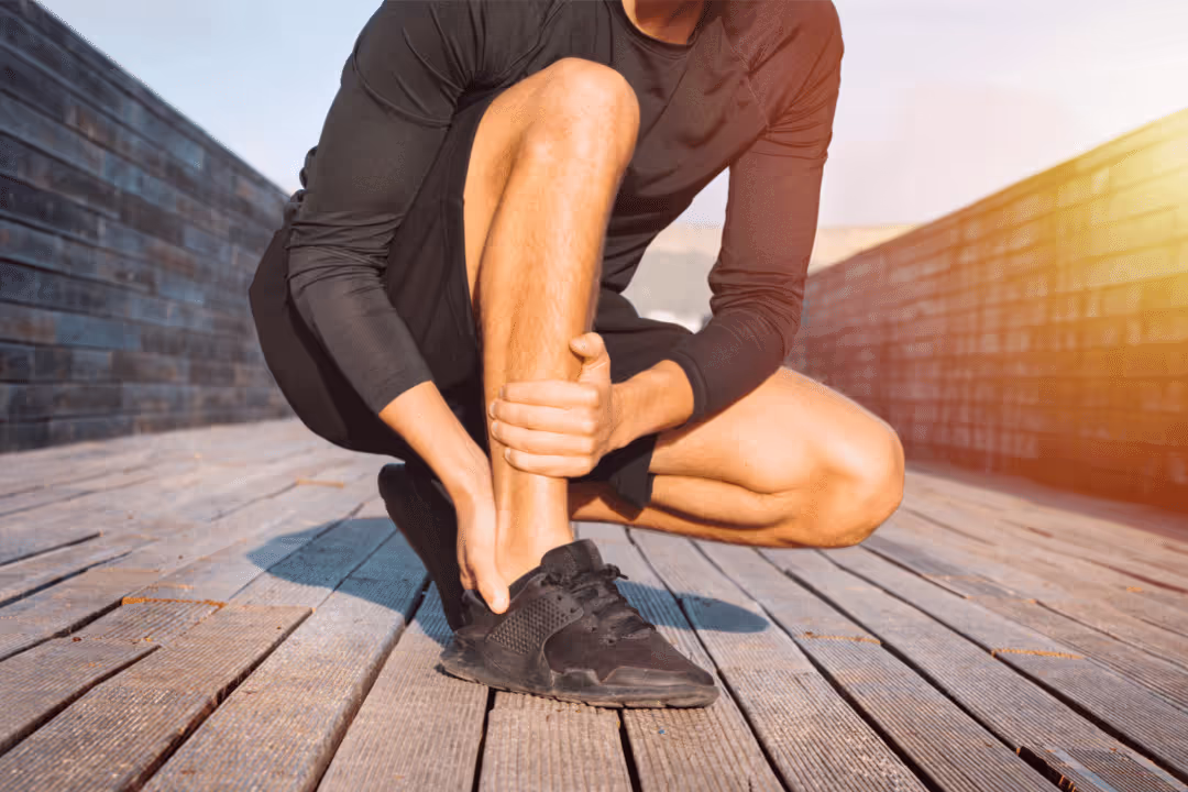 runner with sprained ankle kneeling