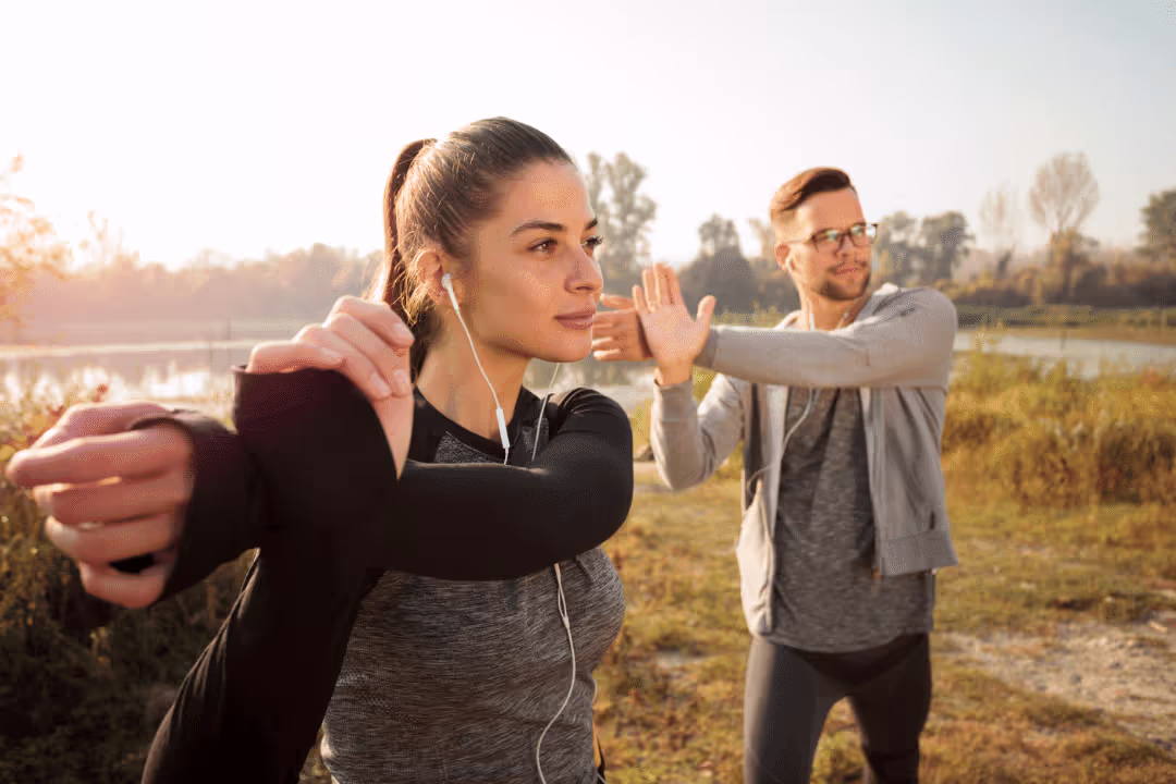 young couple stretching in the morning workout clothing fall