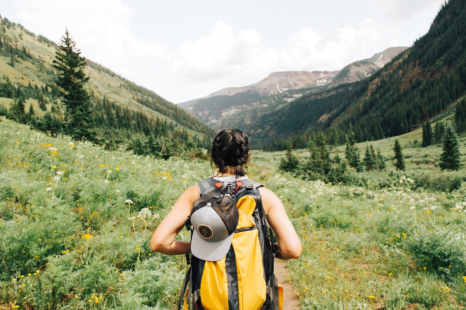 female hiking through trail