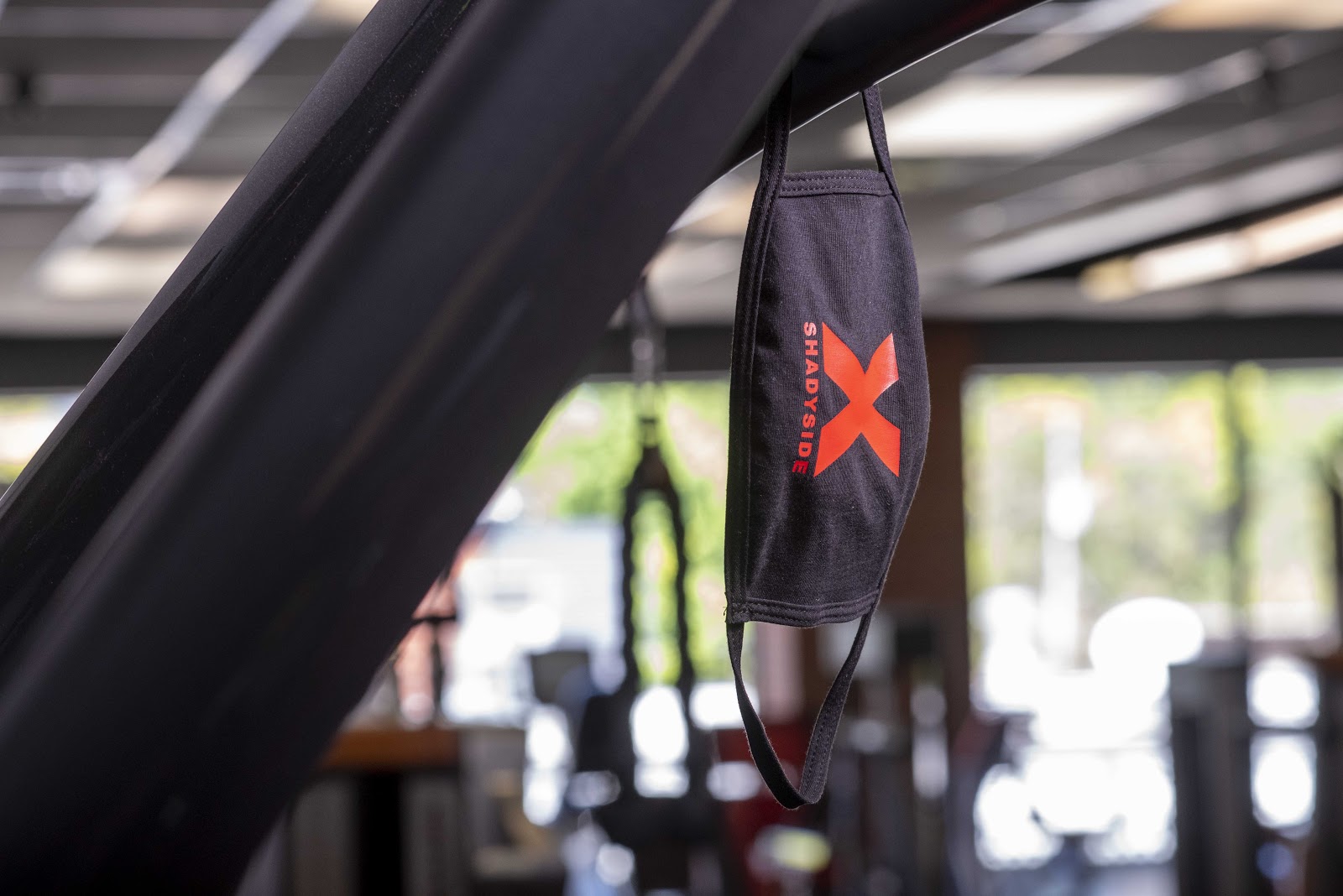 black mask hanging off a piece of fitness equipment