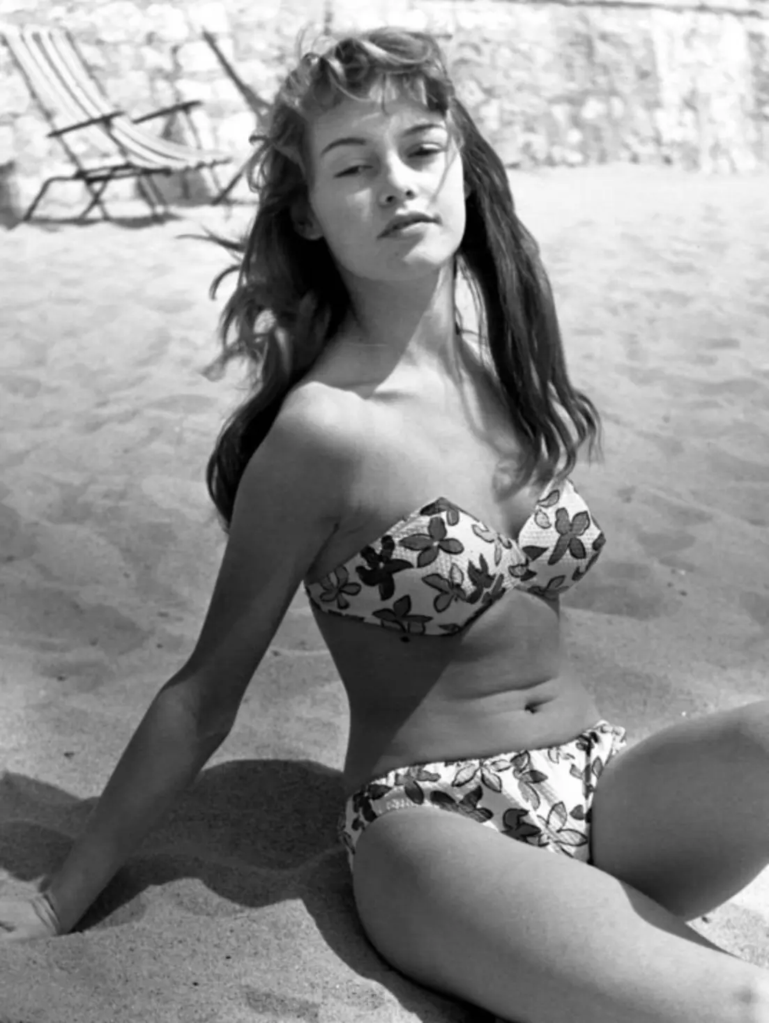 Brigitte Bardot sunbathing in a floral bikini at the 1953 Cannes Film Festival