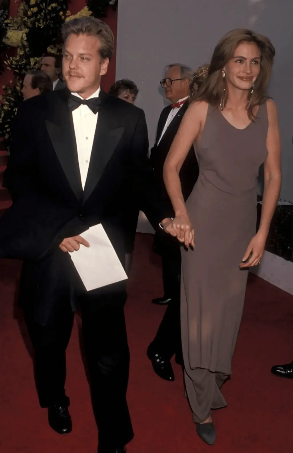 Julia Roberts, accompanied by Kiefer Sutherland, wore Armani to the 1990 Academy Awards, pioneering the trend of wearing the designer on the red carpet