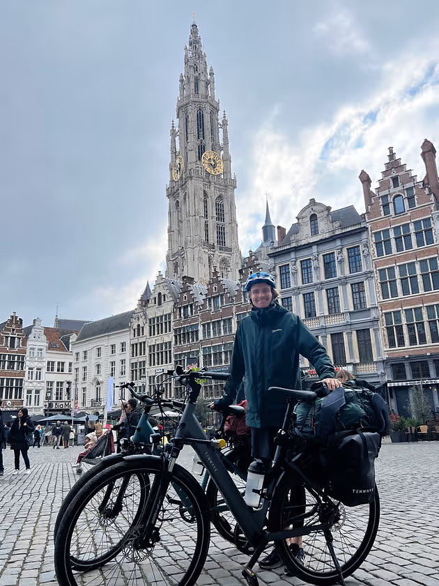 man standing with bike in large square in Antwerp