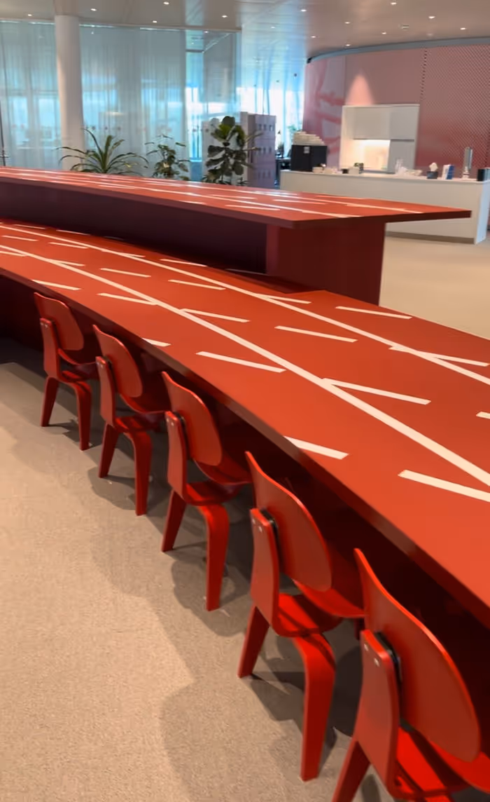 long table designed to look like a running track with matching seats, conference table