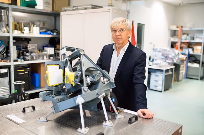 man standing with robotic invention