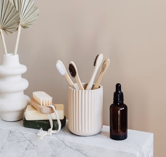 bamboo toothbrushes in glass jar on counter